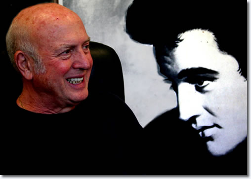 This is Mike Stoller, of the legendary songwriting duo Leiber & Stoller. This was taken in his partner Jerry Leiber's office in their suite of office at 9000 Sunset Boulevard which has long been considered the Brill Building West, because so many great songwriters have offices there, or used to. There was a giant poster of Elvis behind him, which was a blow-up of the original sheet music of their song 'I Want To Be Free', which Elvis cut. Here Mike is smiling at Jerry, who is sitting at his desk, drinking coffee.